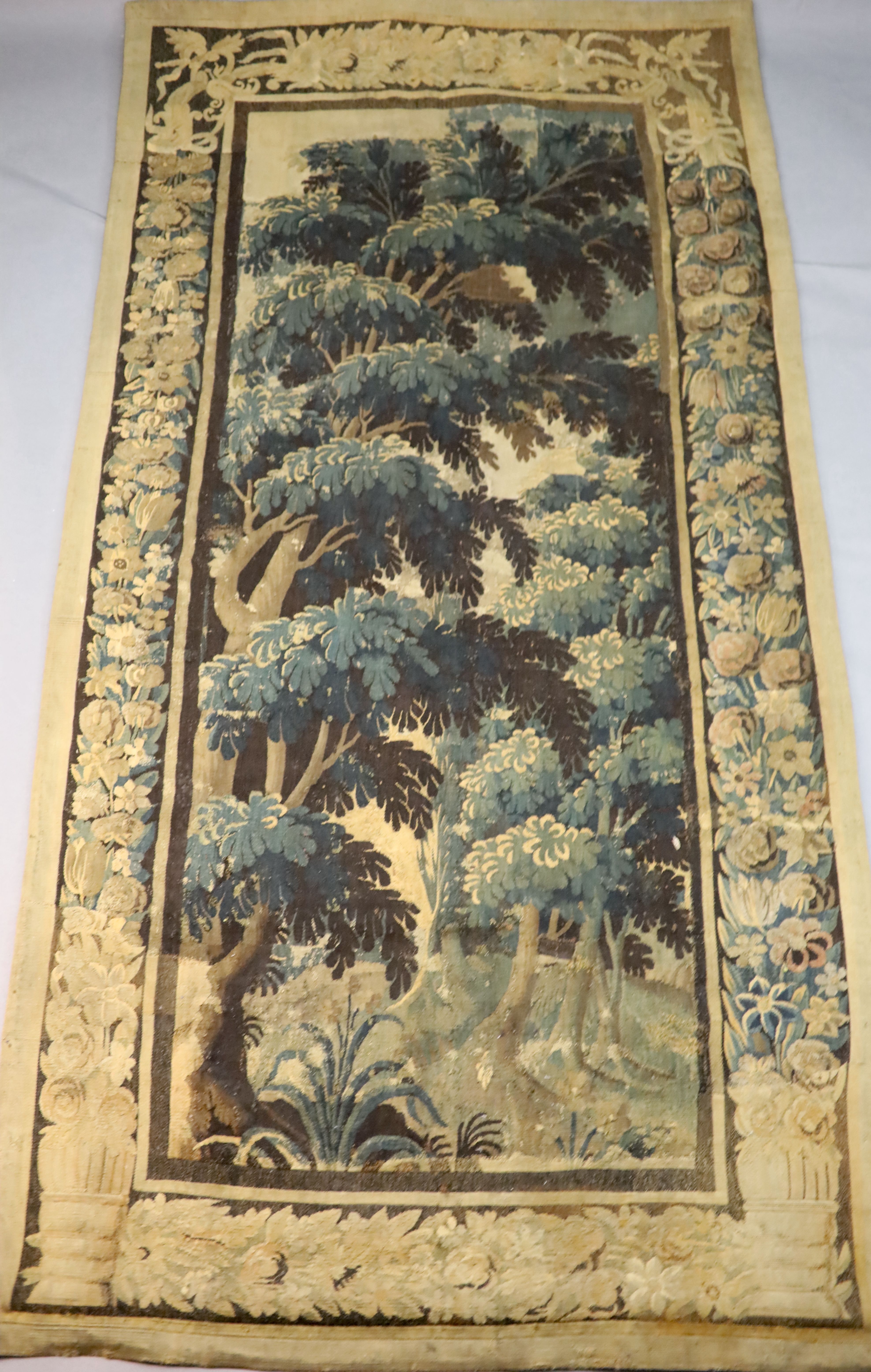 A 17th century Flemish verdure tapestry wall hanging, 8ft 1in. x 3ft 11in.